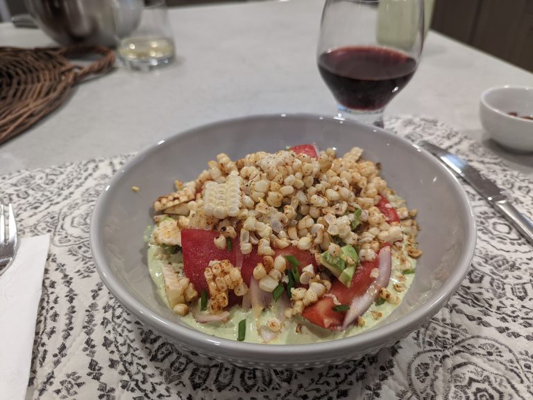 Green garden salad with corn, onions, jalapeños and tomatoes