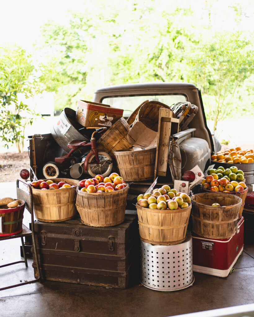 Vintage pick-up truck surrounded by baskets of fresh produce at Biggers Market Wilmington, NC