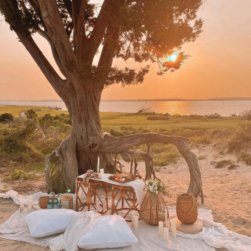 picnic setup at sunset by Collective Law