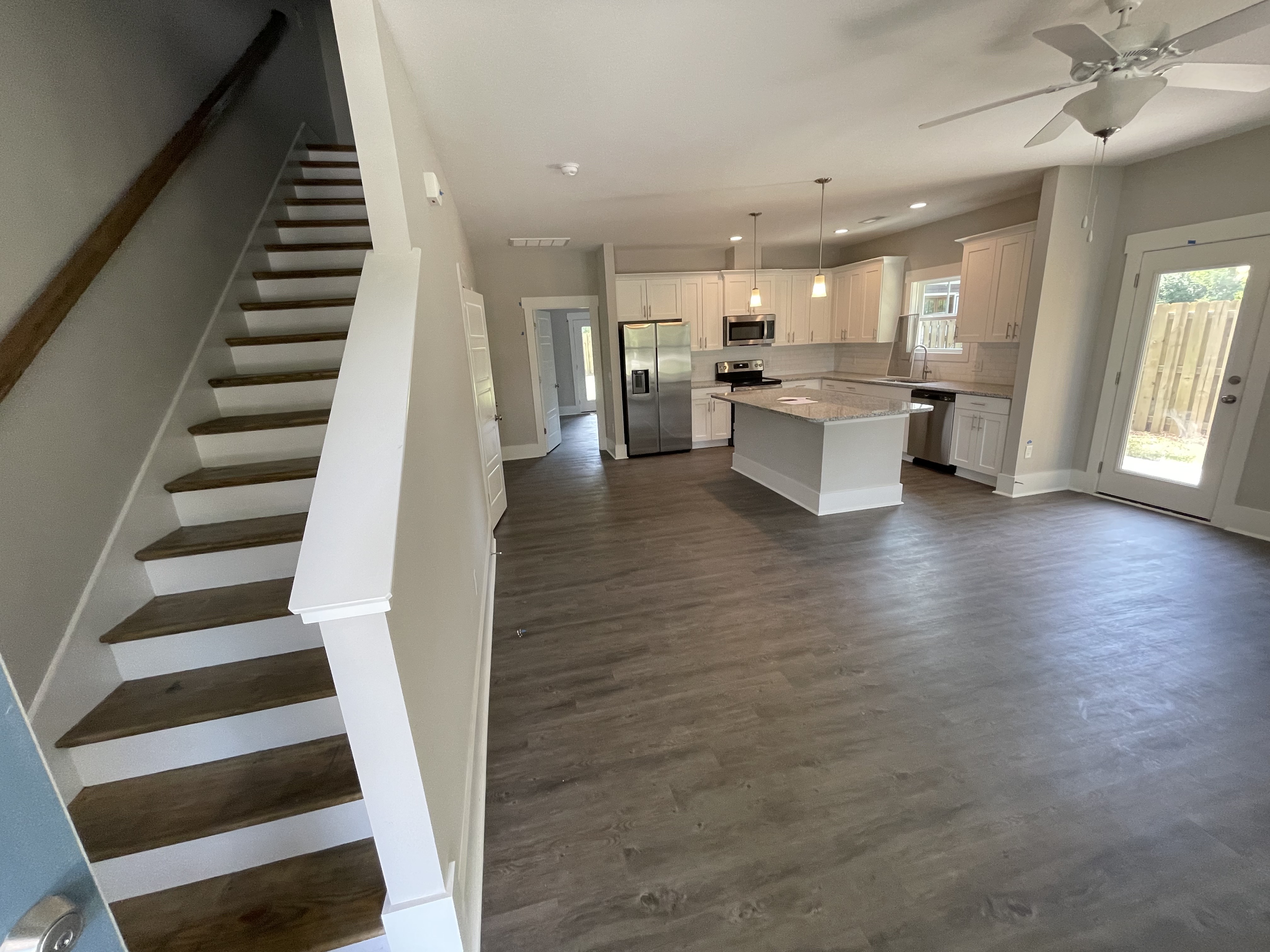 interior stairs living room and kitchen open floor plan; affordable housing property Arth Real Estate Wilmington North Carolina