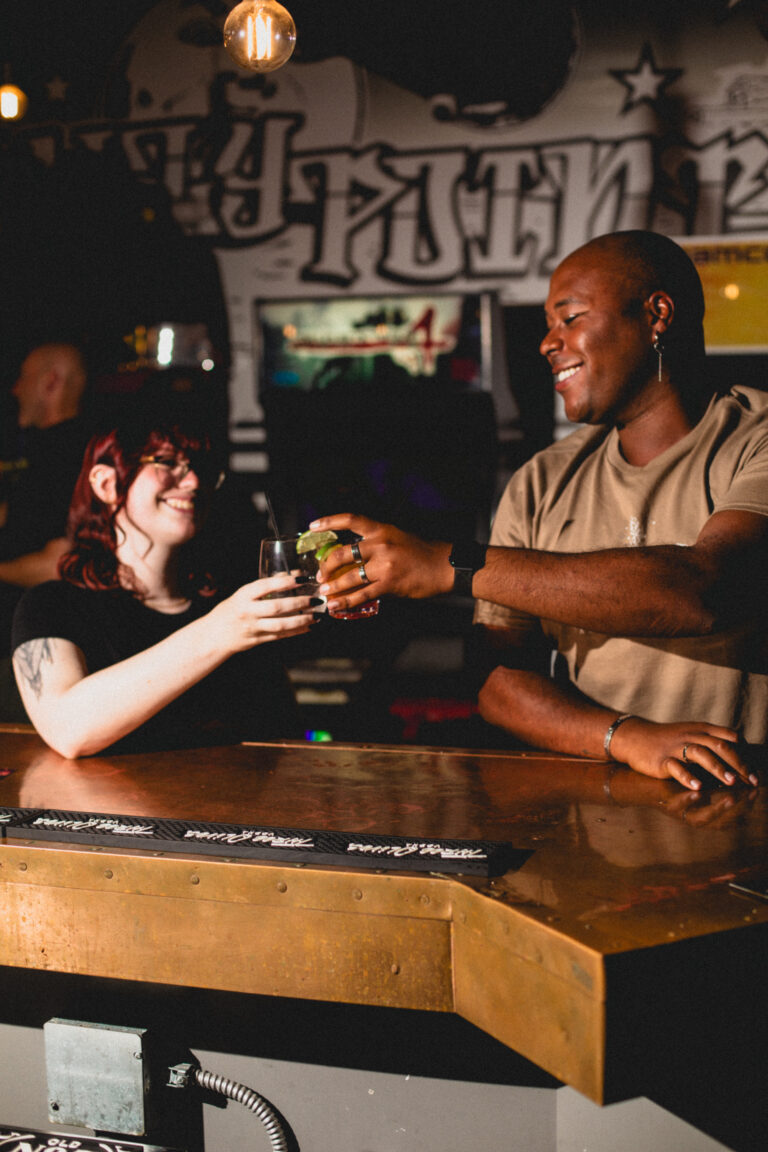 Two people saying cheers to Local's Summer in Wilmington