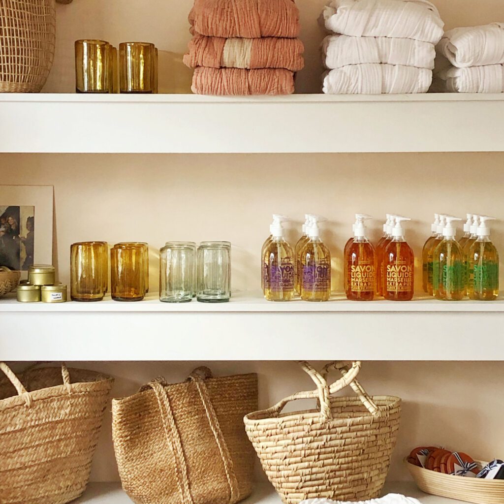 shelves stocked with fragrances, baskets, and towels