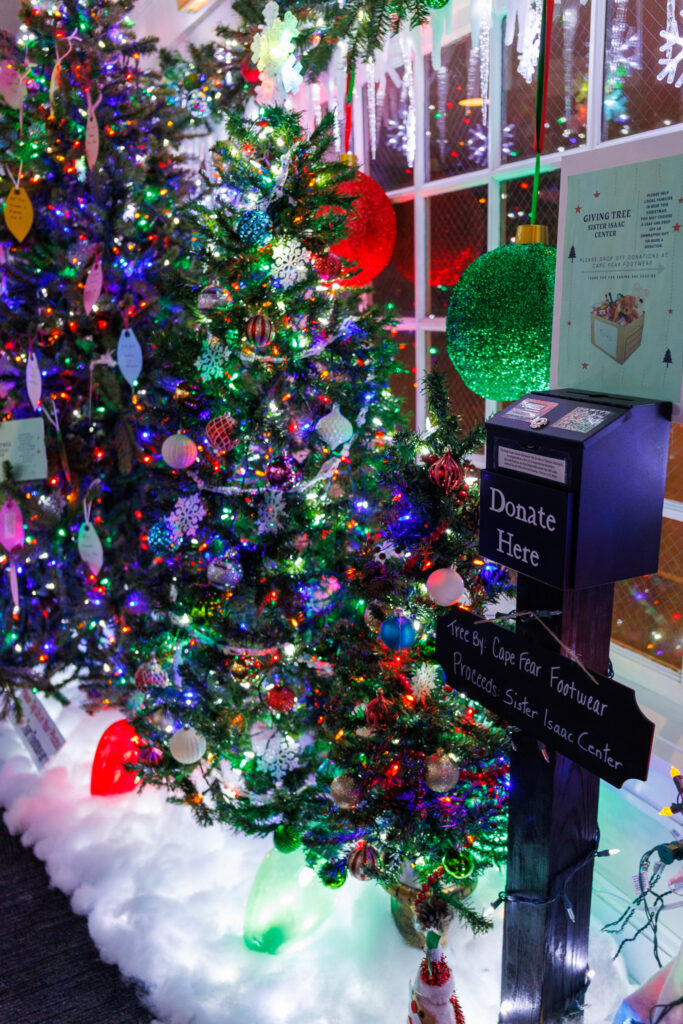 Donation box and Christmas tree at Cape Fear Footwear, winner of Downtown Spirit in Wilmington's Battle of the Bulbs