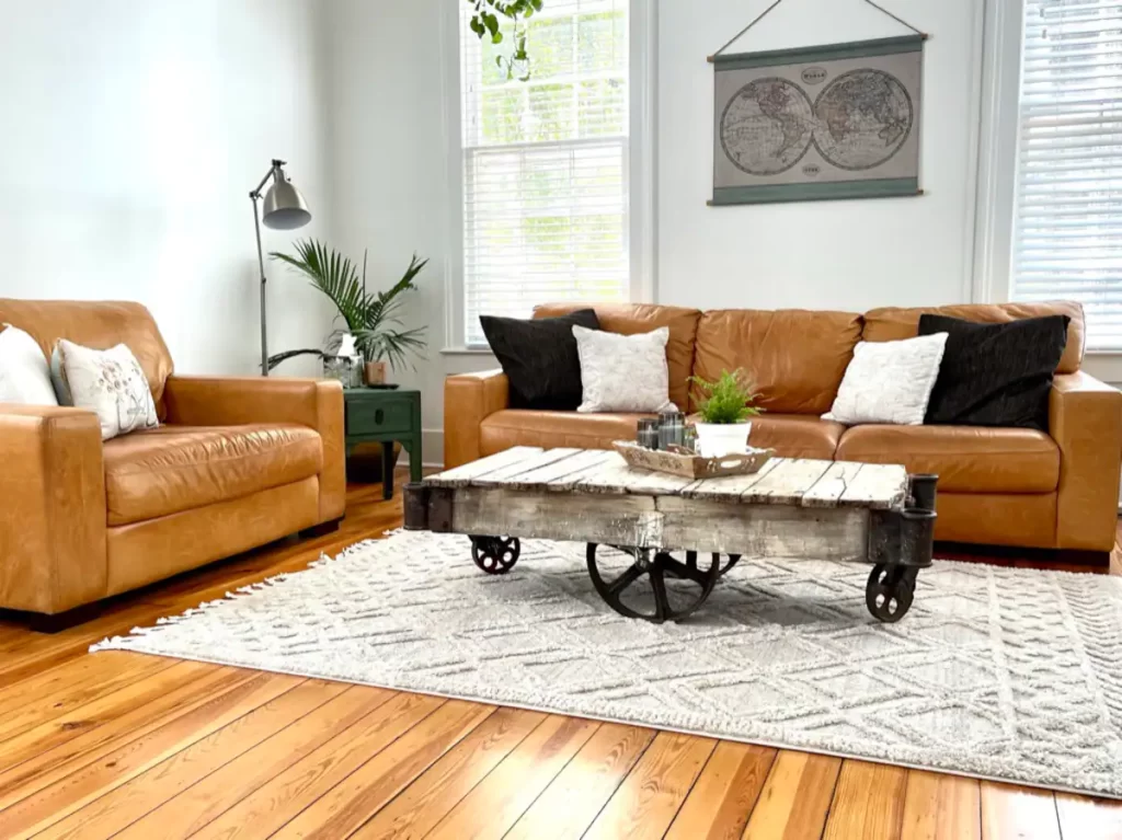 Interior of Casa Verde airbnb, warm brown couches, interesting decor, plants and greens