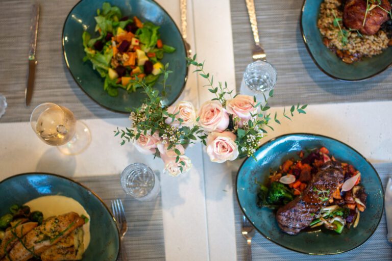 overhead view of a beautiful dinner spread at The Second Glass, pink flowers in a vase prix fixe menus for Valentine's Day