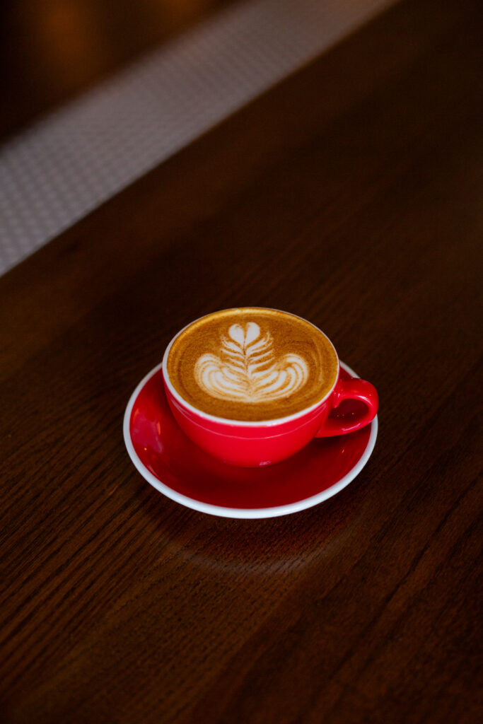 Hot latte on a bar top at Bespoke for Local Spots for College Students on a Budget Arth Real Estate Group