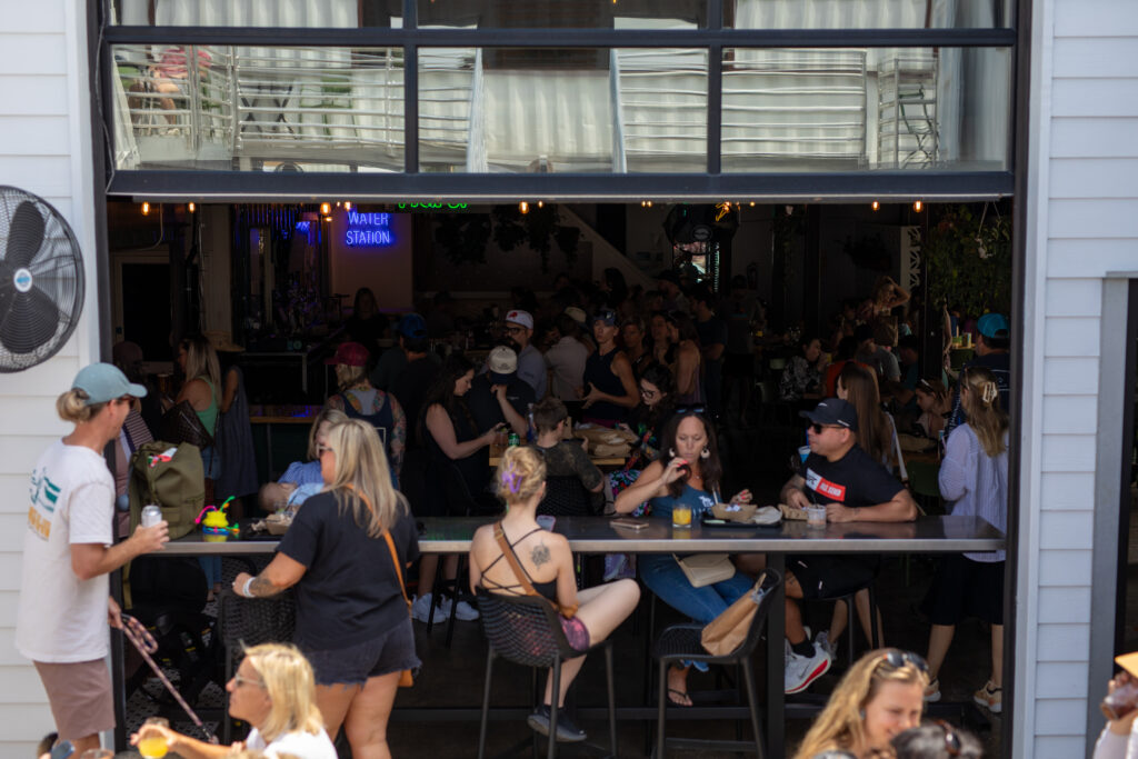People gathered on the patio of a business in the Cargo District in downtown Wilmington